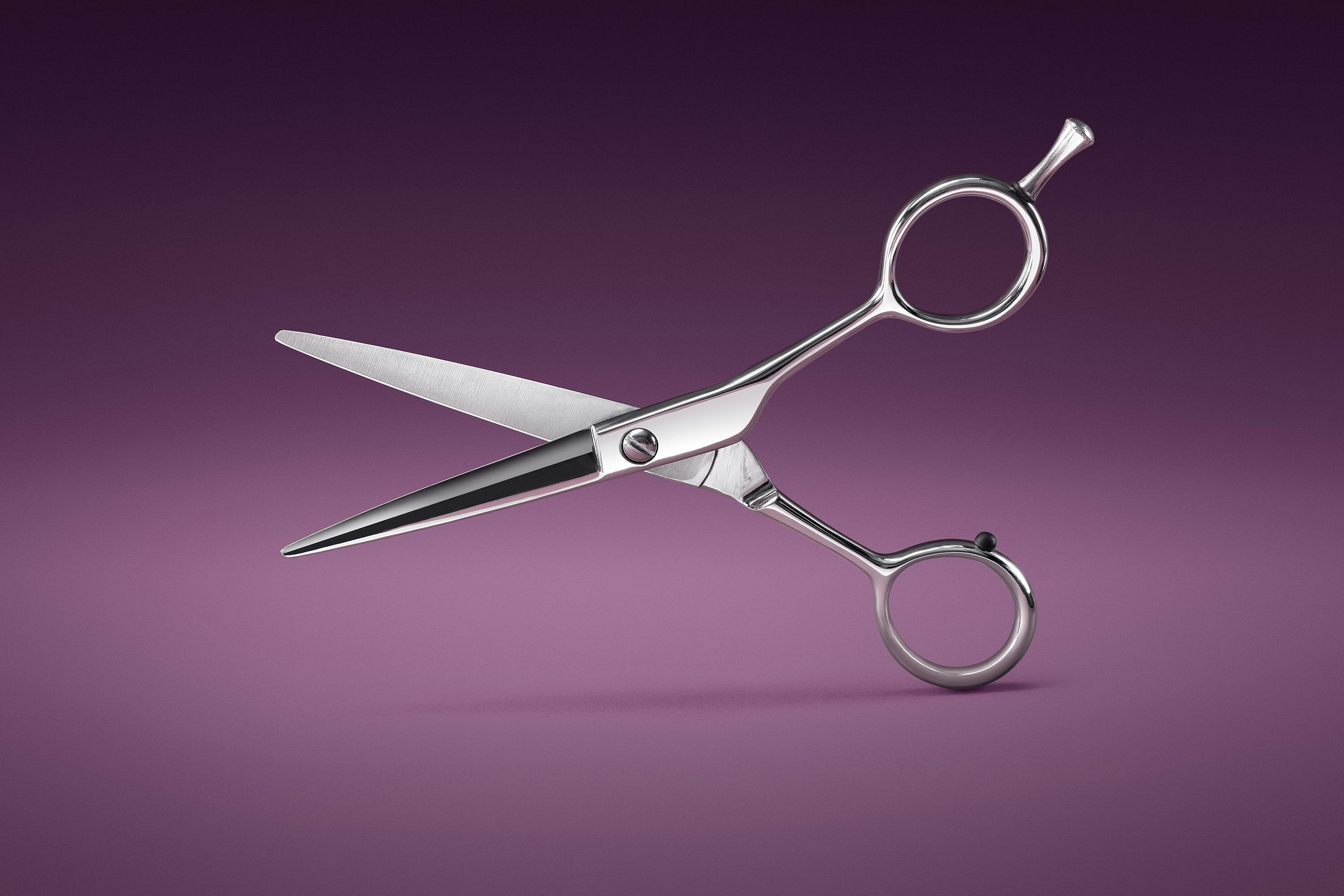 Packshot of a hairdresser's scissors on a velvet background