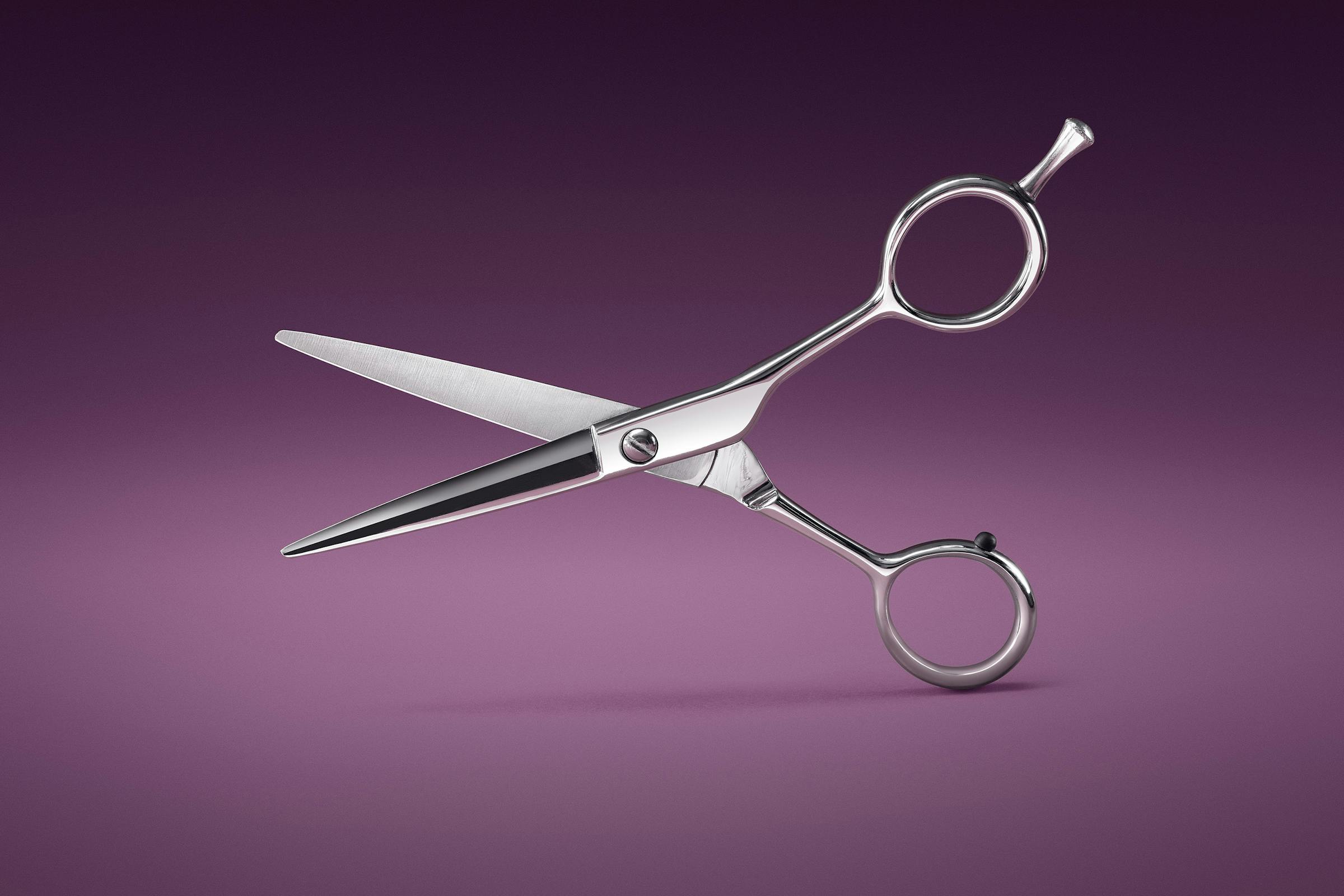 Packshot of a hairdresser's scissors on a velvet background