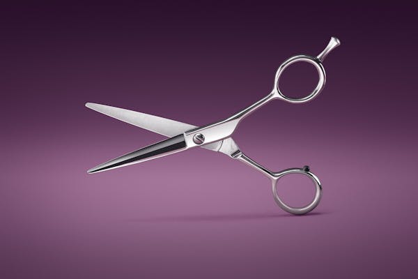 Packshot of a hairdresser's scissors on a velvet background