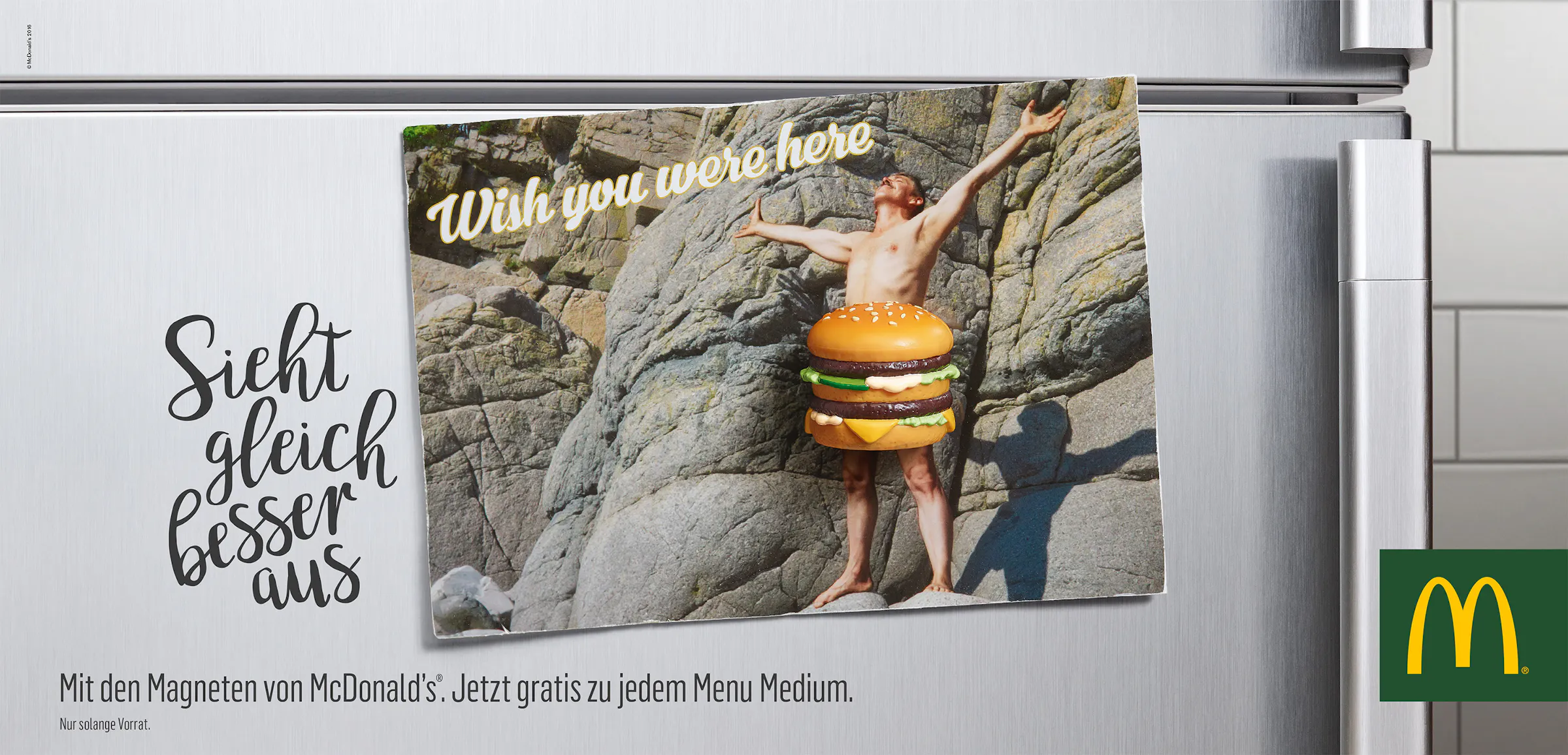 Postcard on a fridge with a magnet in the shape of a burger