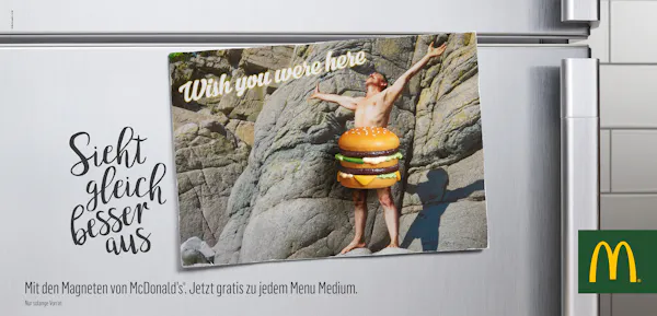 Postcard on a fridge with a magnet in the shape of a burger