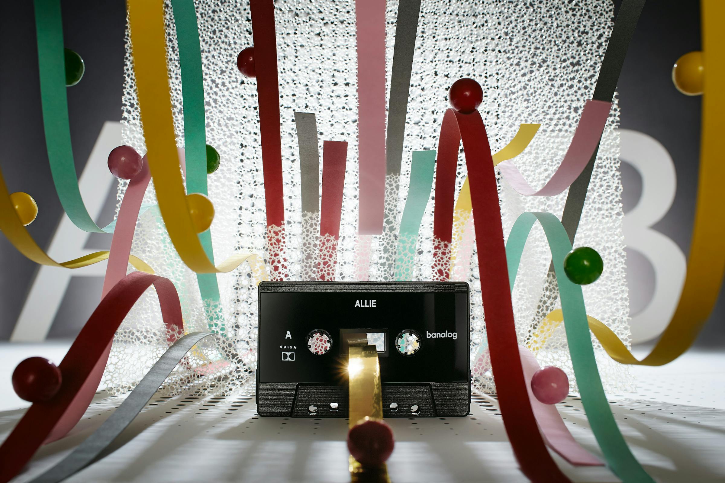 Cassette in an abstract set design with colourful loops in tongue form