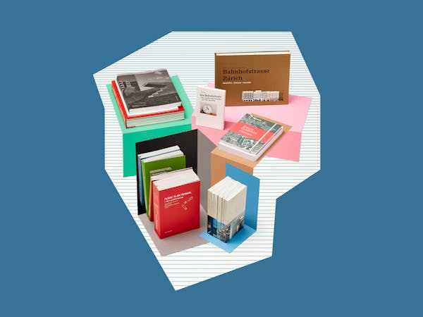 A group of architecture books on a striped paper background