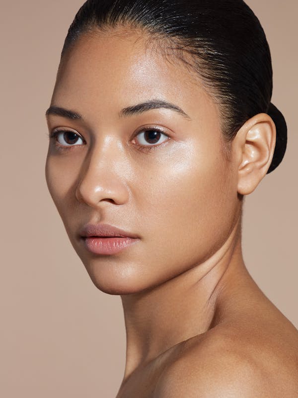 Beauty shot of a young woman with her black hair pulled back tightly