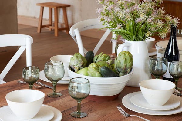 Close-up shot of white crockery with vegetables from the garden on a table