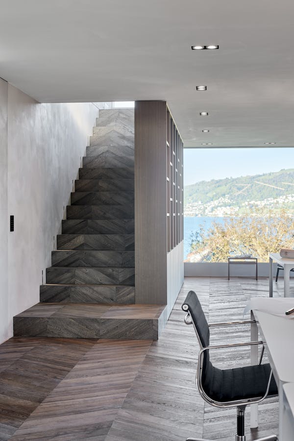 Staircase with parquet flooring and an office desk