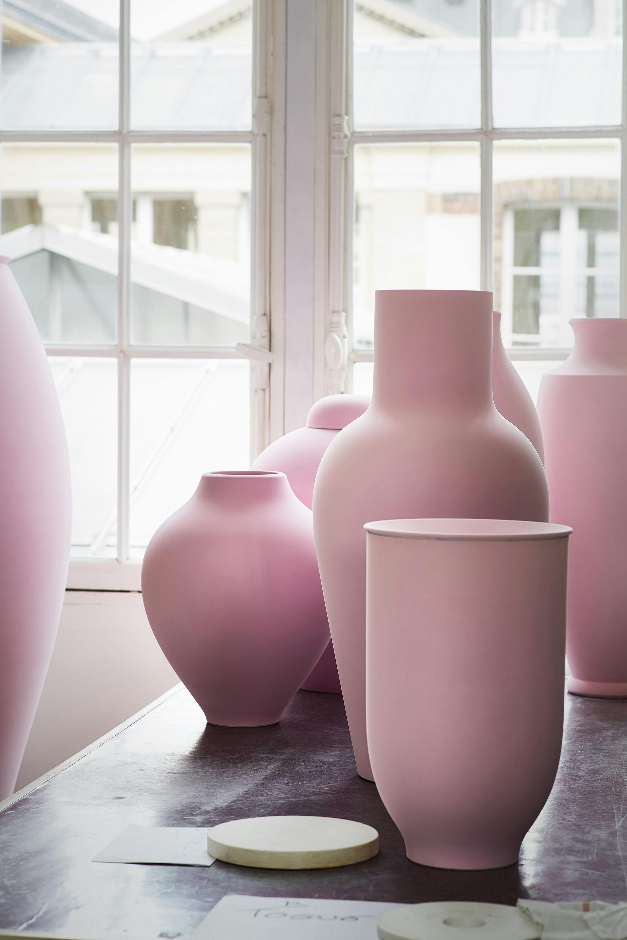Large pink porcelain vases on a table