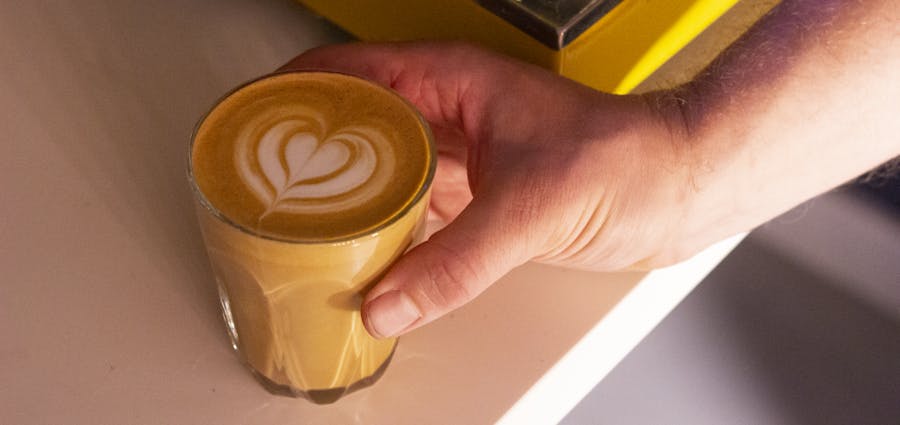 Heart latte art in a glass.