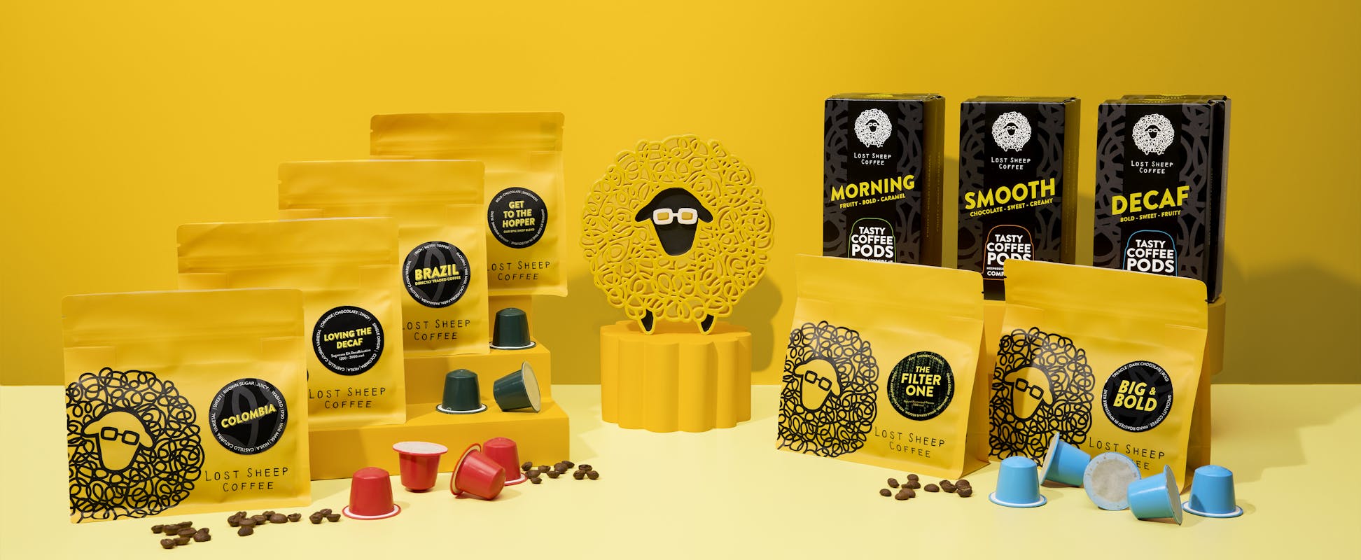 A collection of Lost Sheep Coffee Products including speciality coffee beans and Nespresso coffee pods on a yellow background