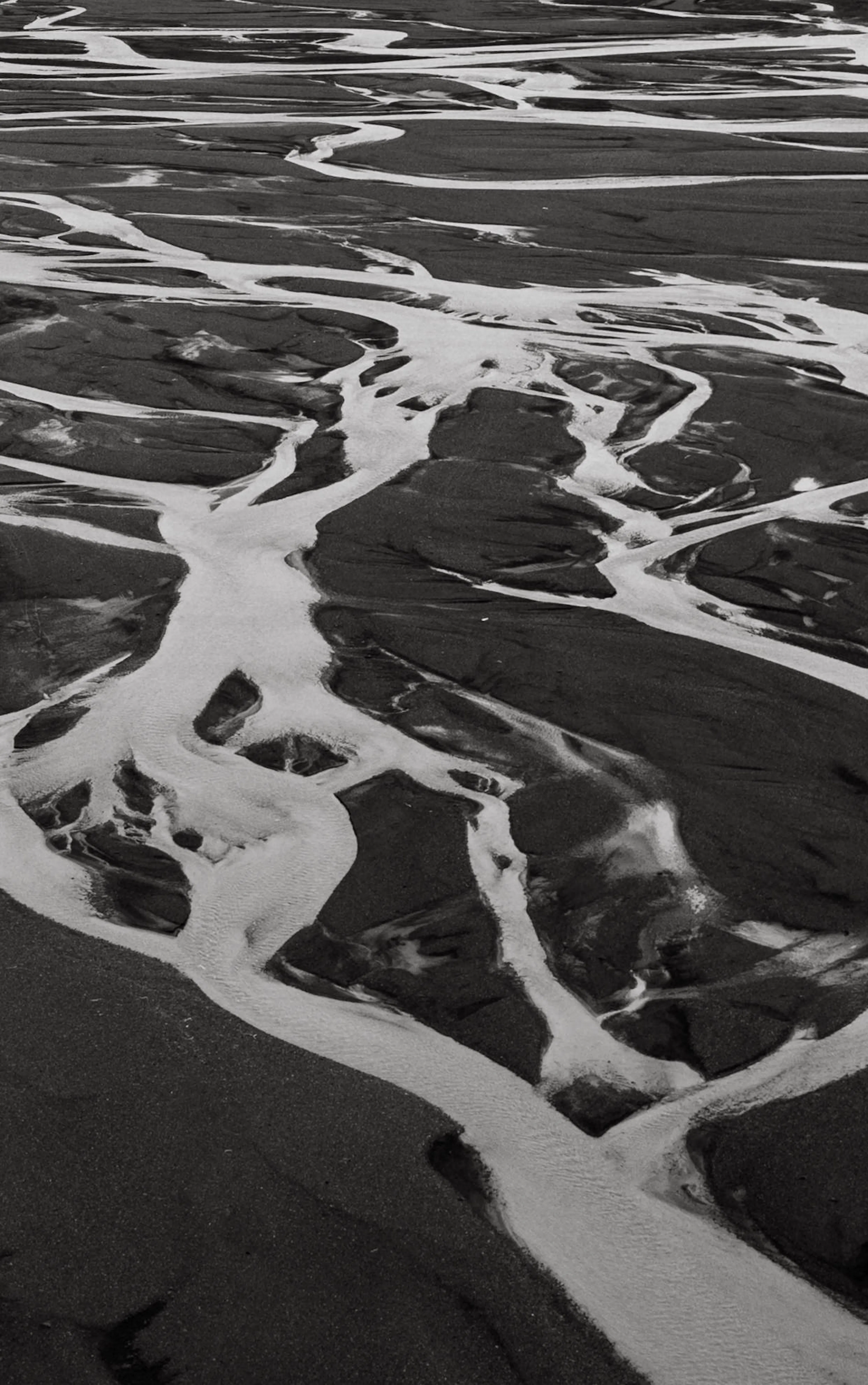 Glacial river aerial black sand