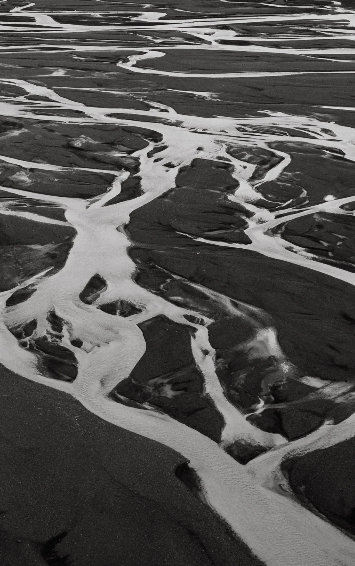 Glacial river aerial black sand