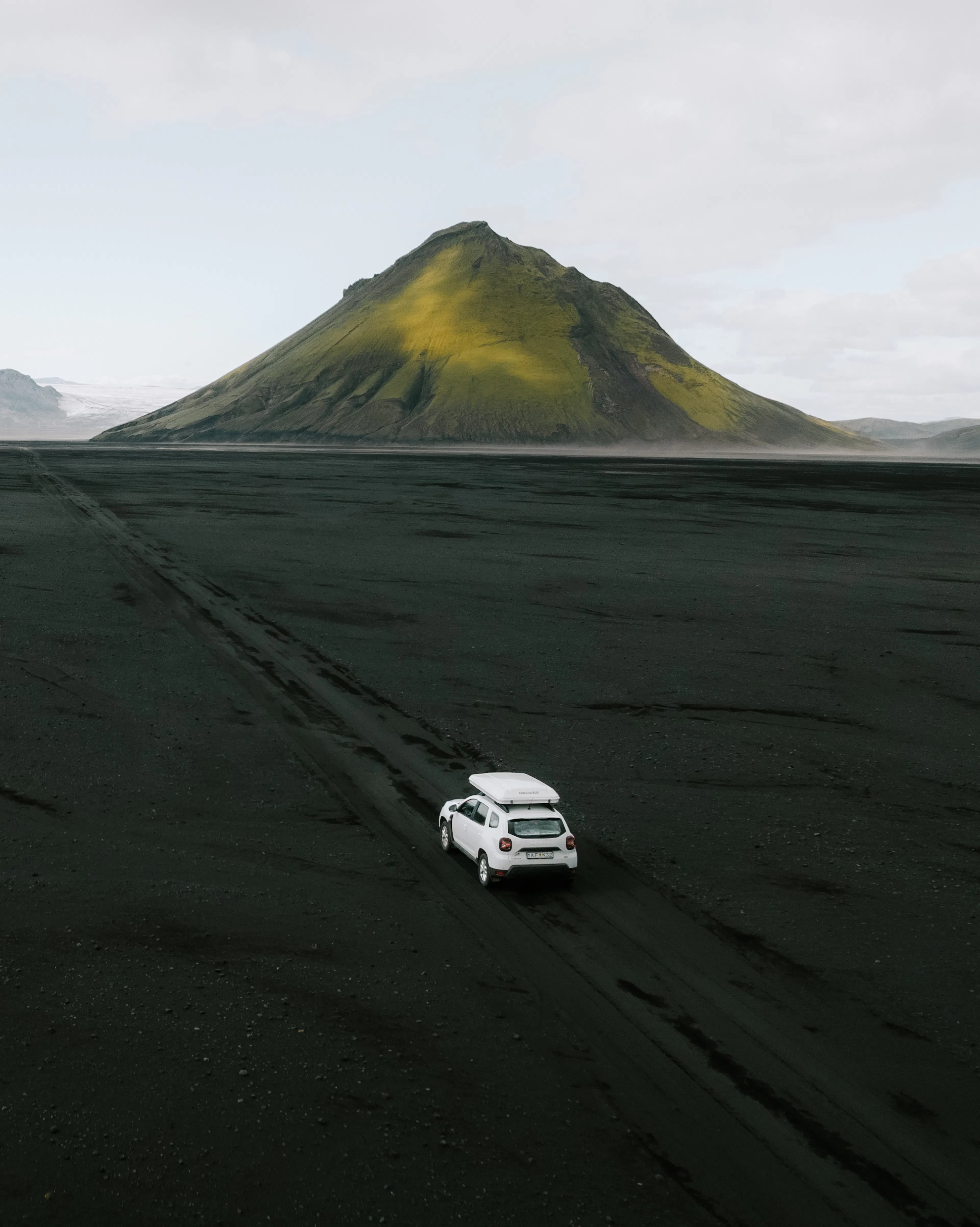 White suv rooftent black sand aerial