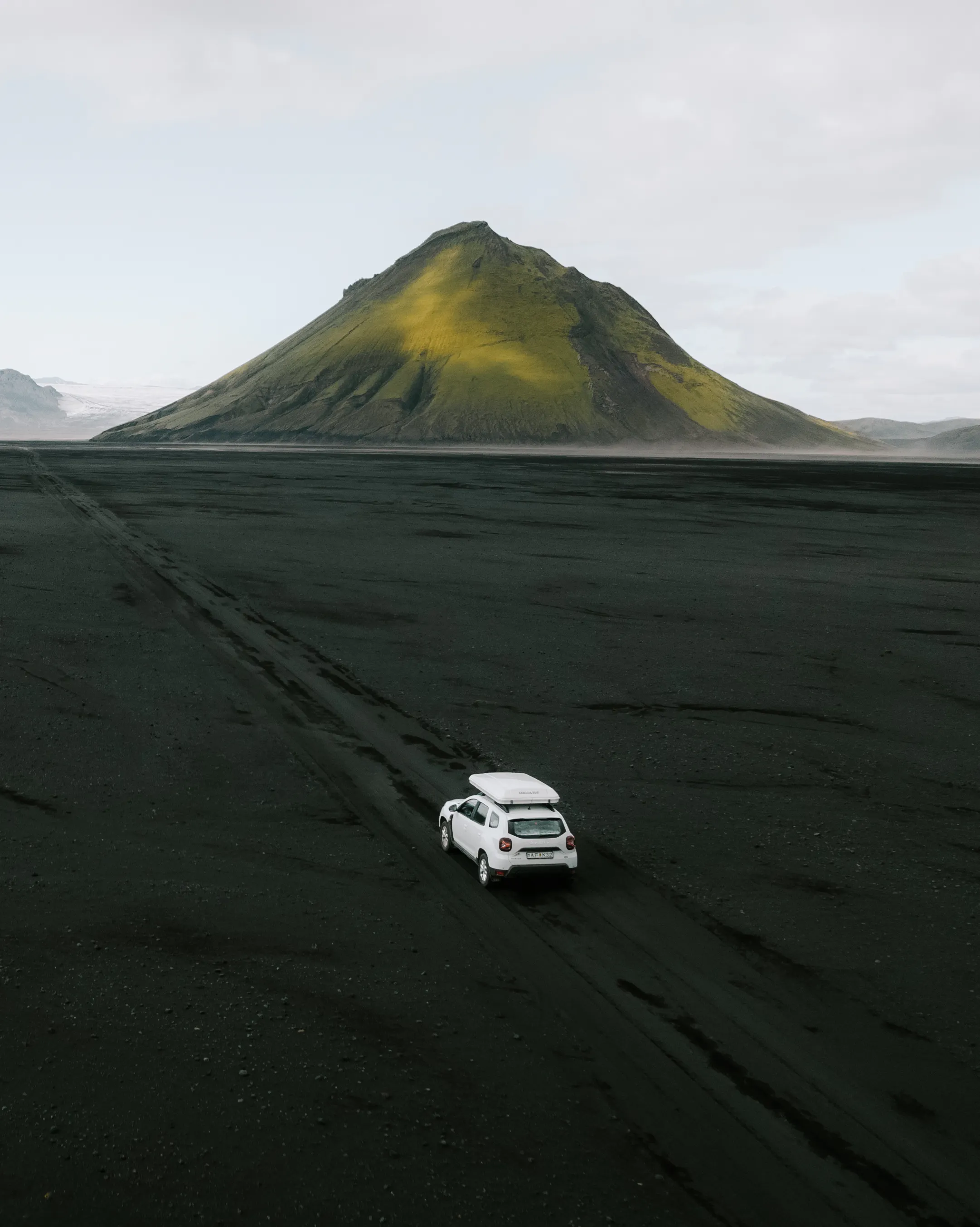 White suv rooftent black sand aerial