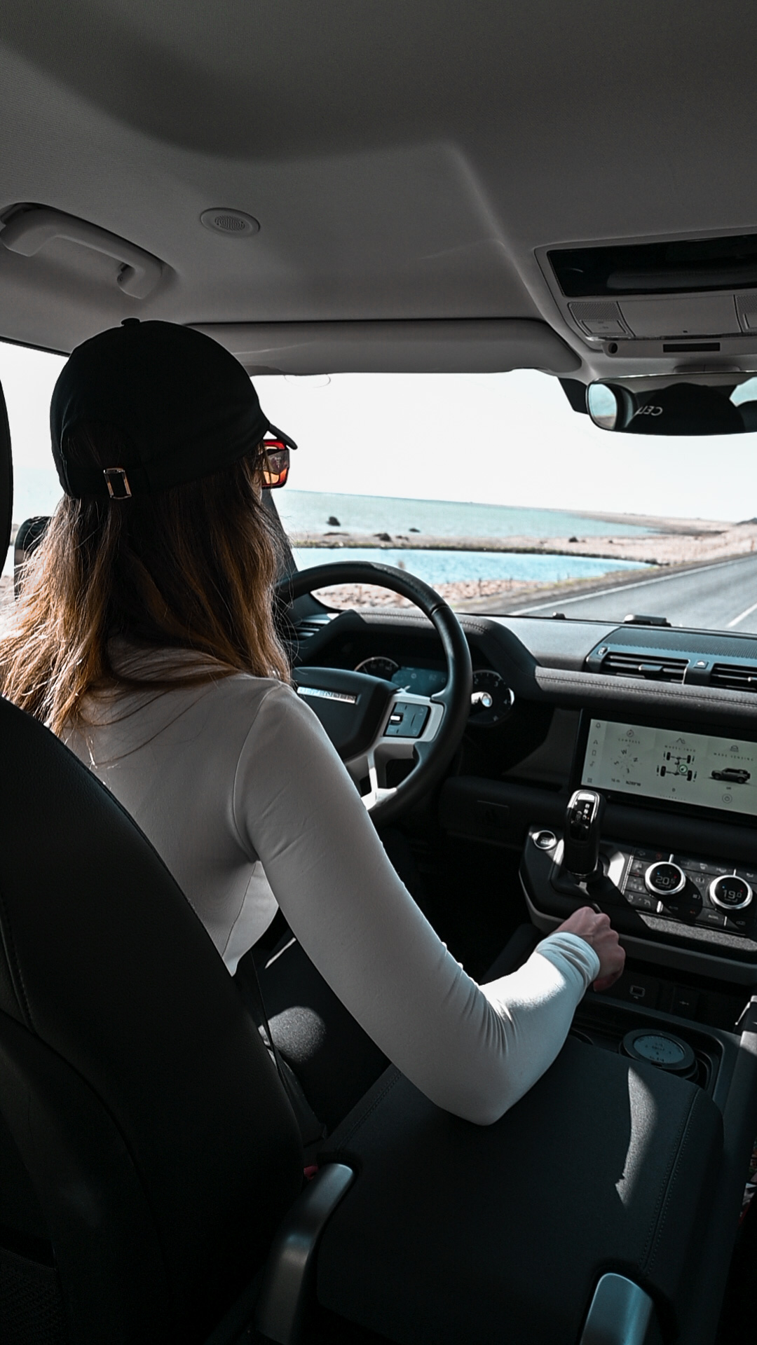 Woman driving defender coastal road