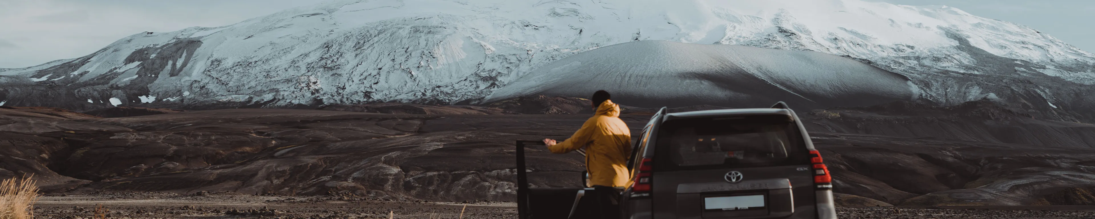 Traveler yellow jacket suv snowy mountain