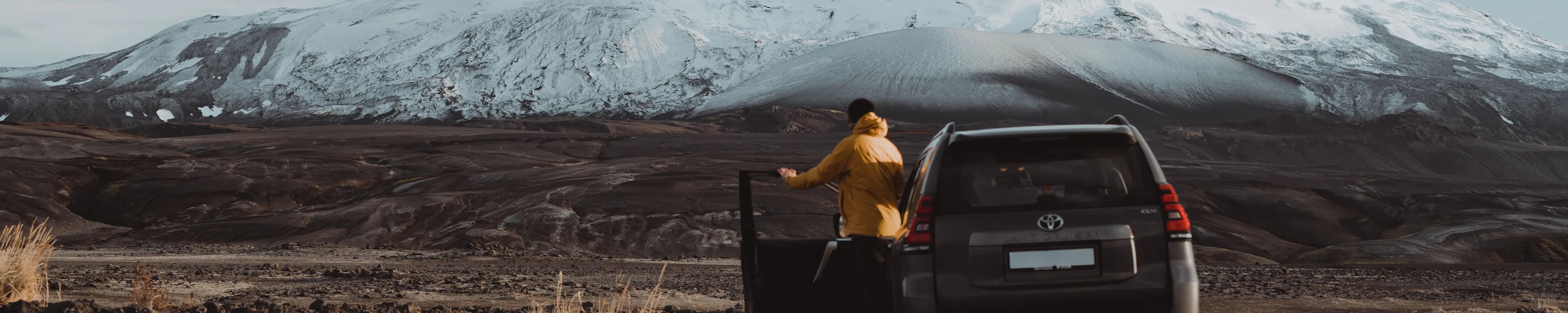Traveler yellow jacket suv snowy mountain