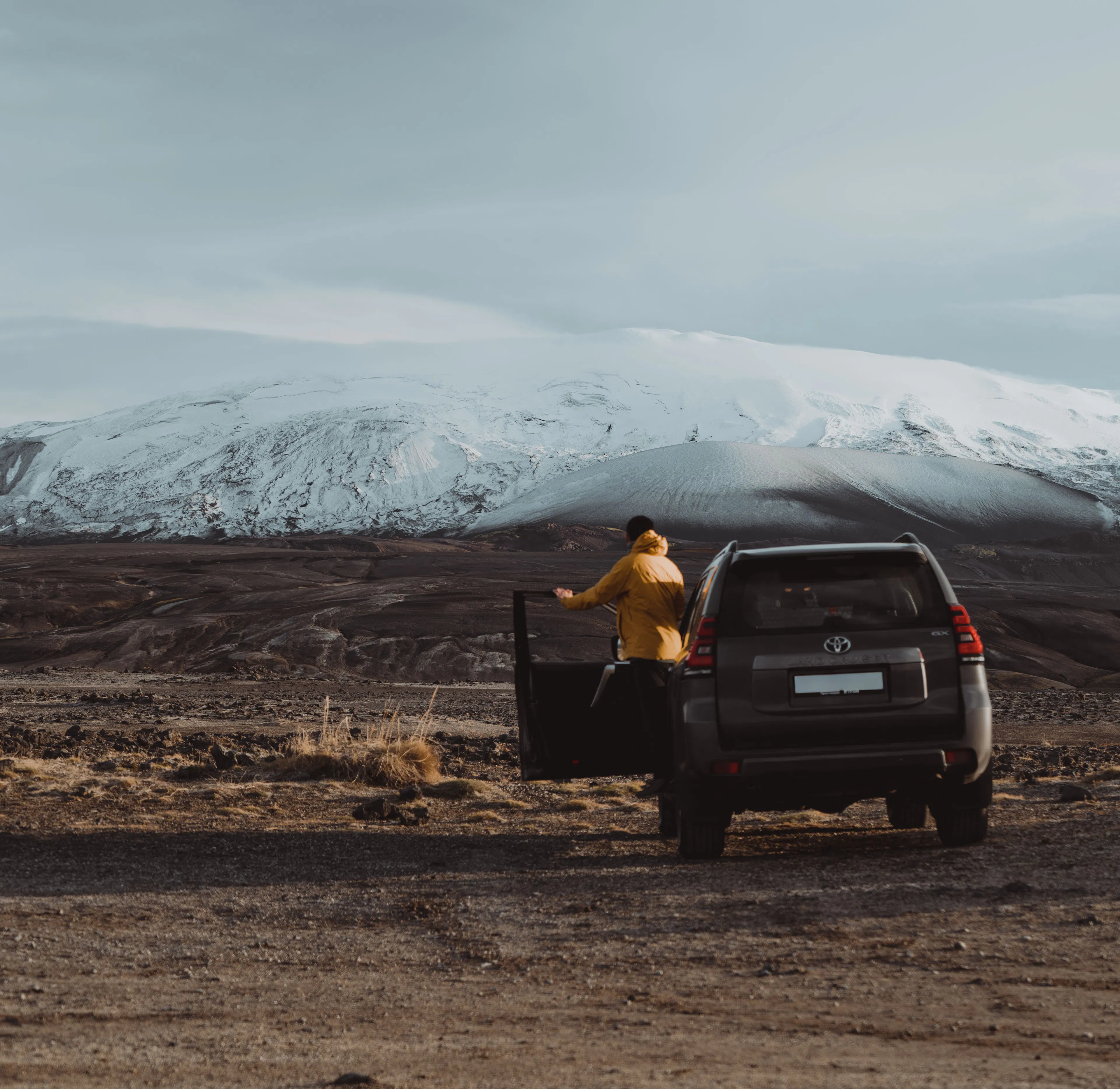 Traveler yellow jacket suv snowy mountain