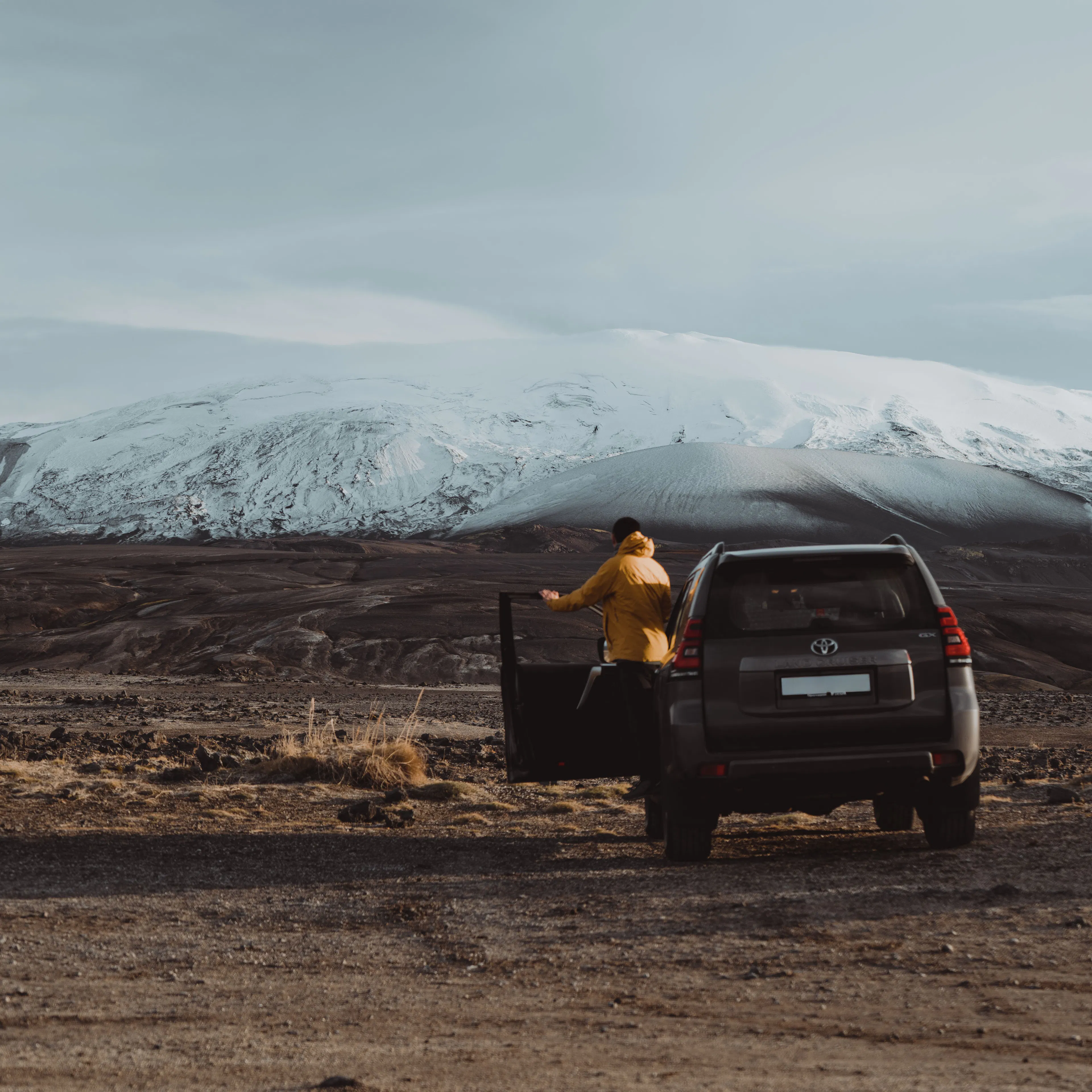 Traveler yellow jacket suv snowy mountain
