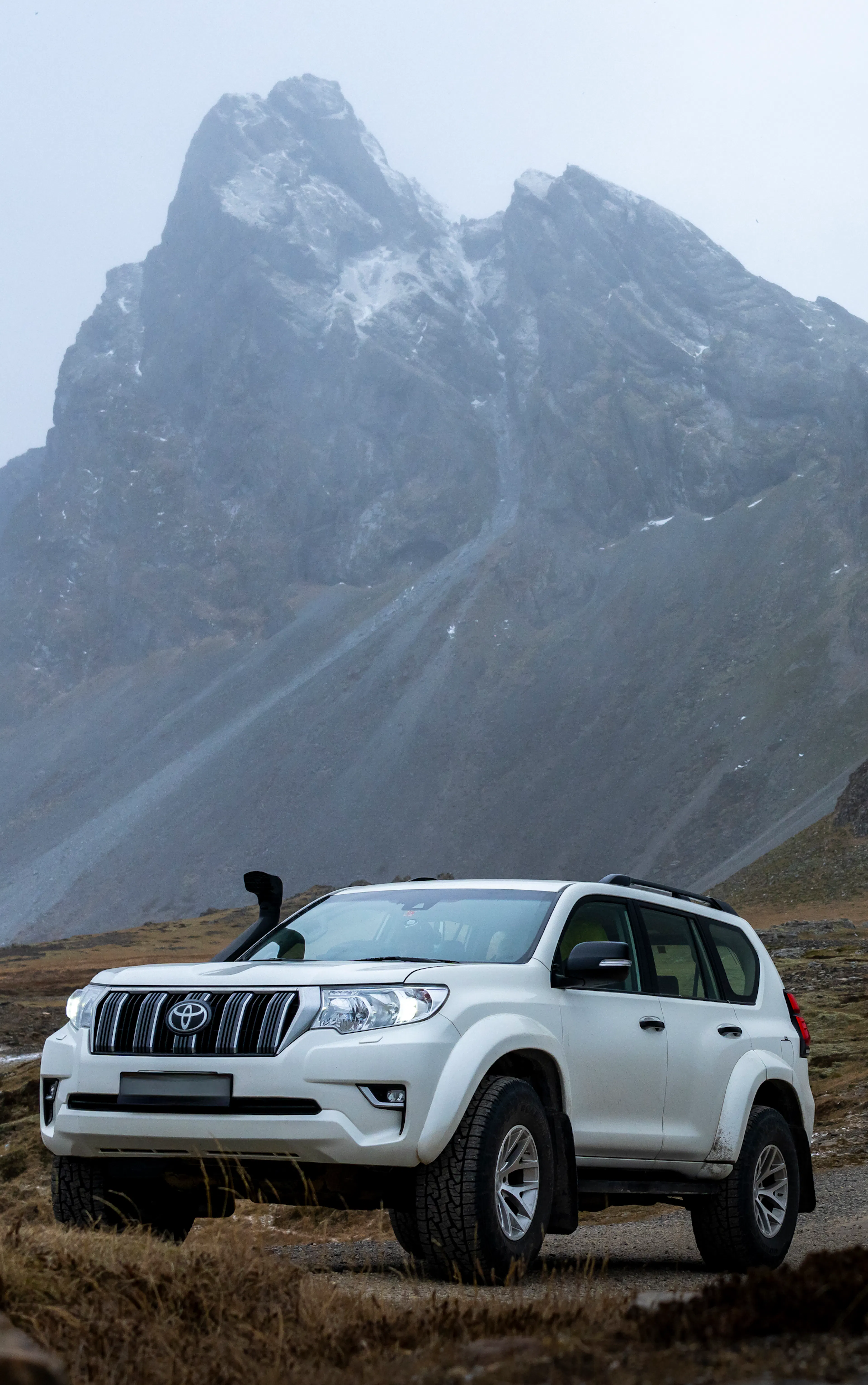 White land cruiser jagged mountains