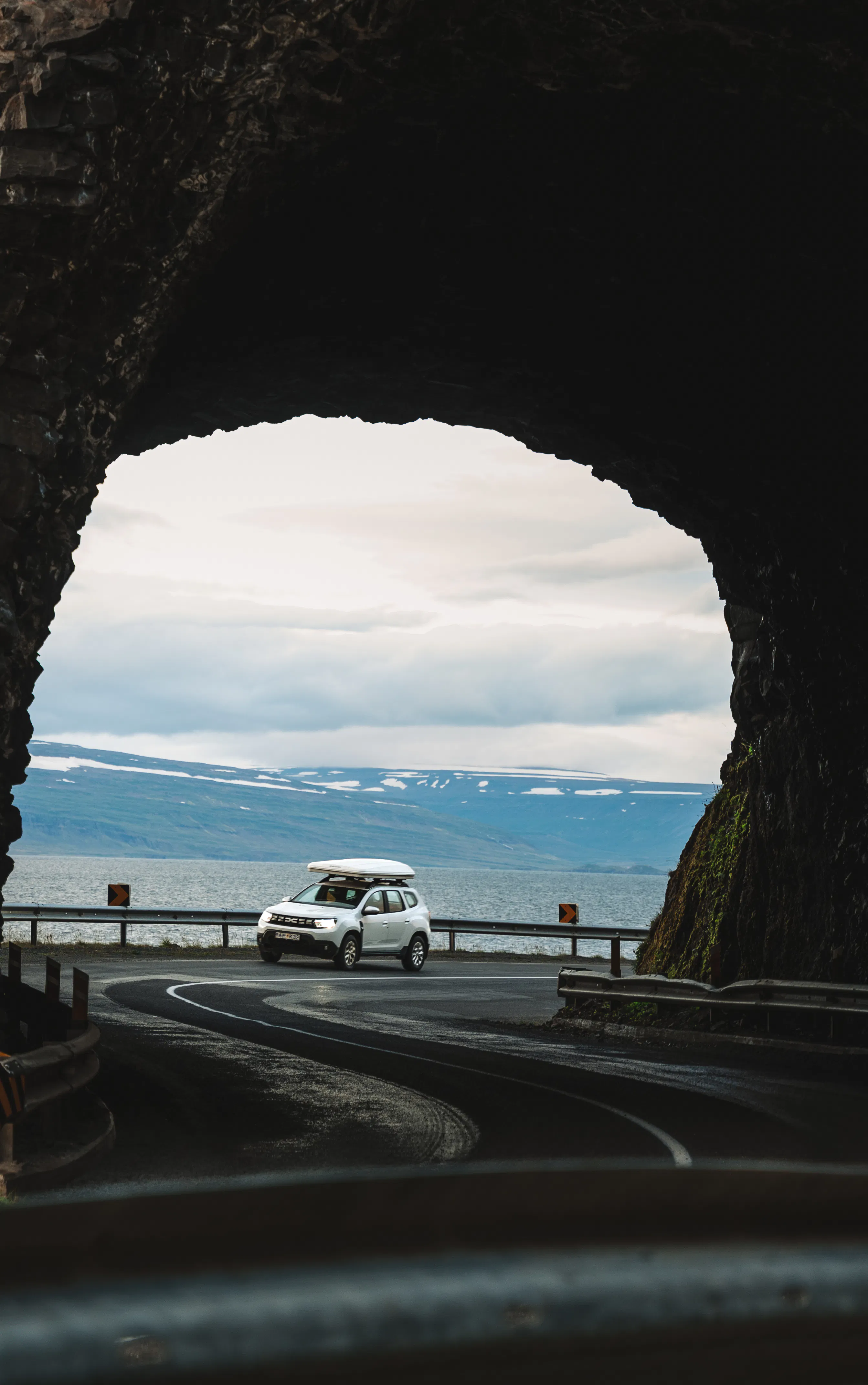 White suv rock arch tunnel