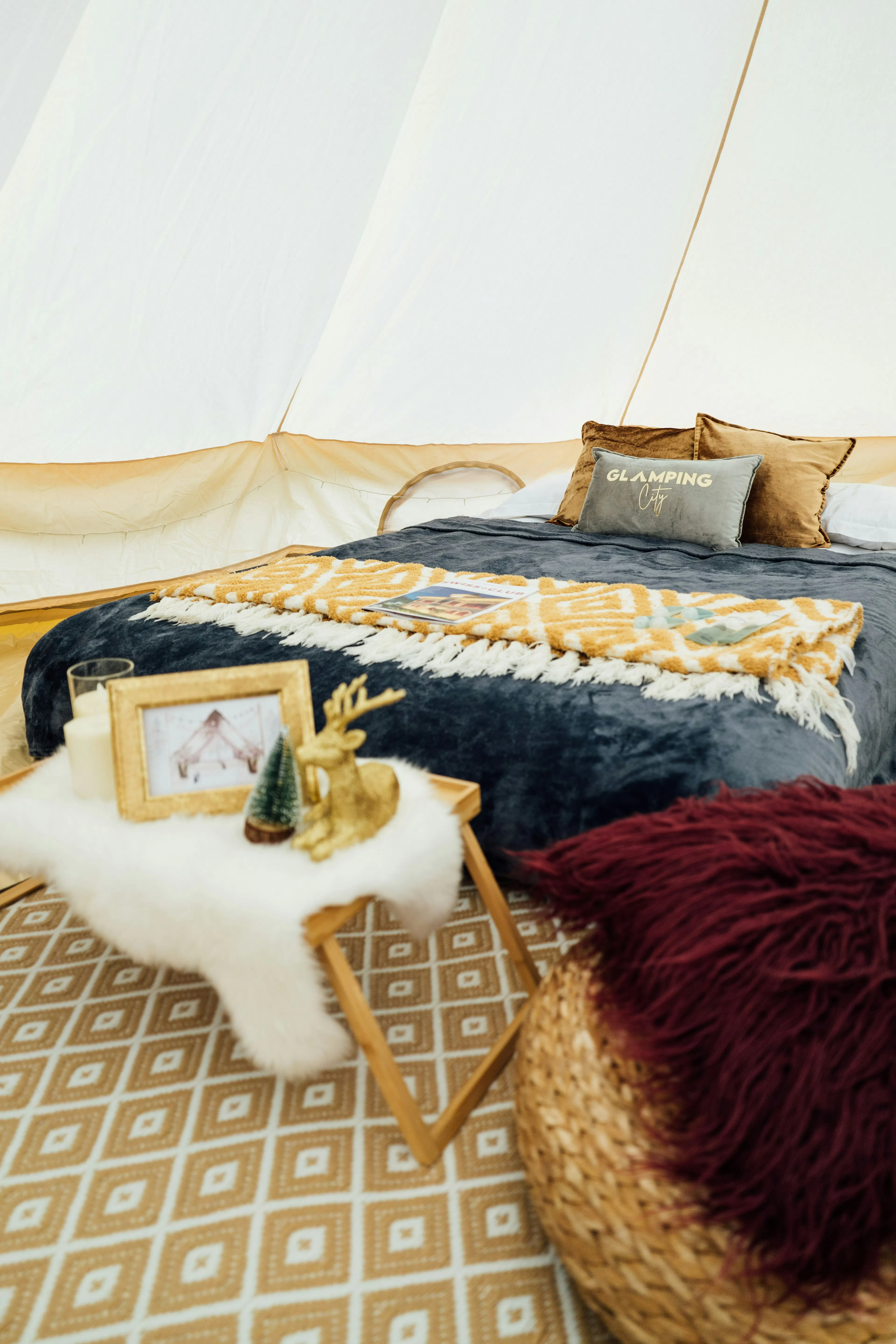 inside of a glamping tent with luxury bed as an example of hen do idea