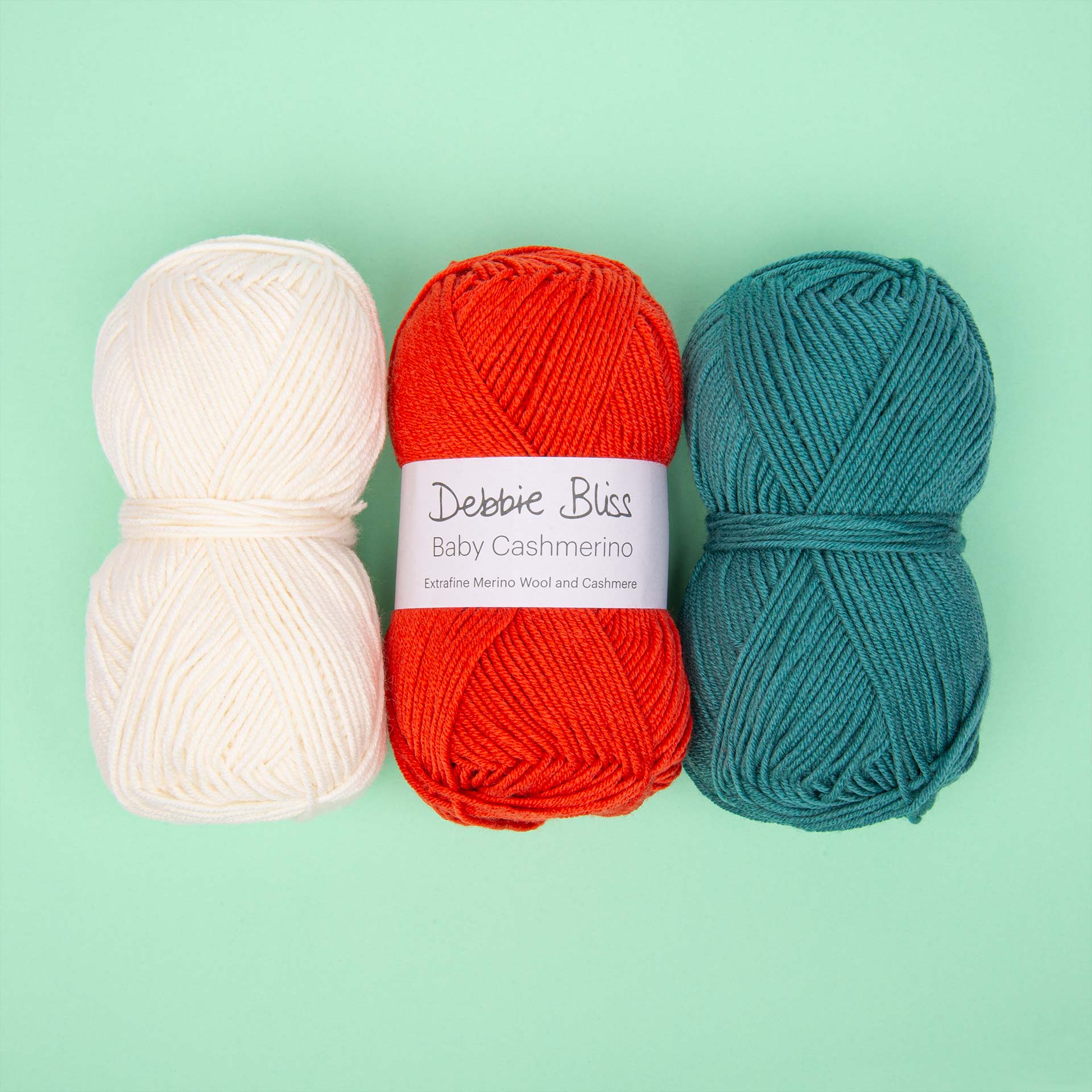 Debbie Bliss Baby Cashmerino yarn in white, green and red shades