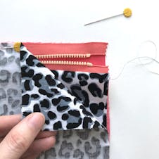 close up of second side of fabric pinned into place