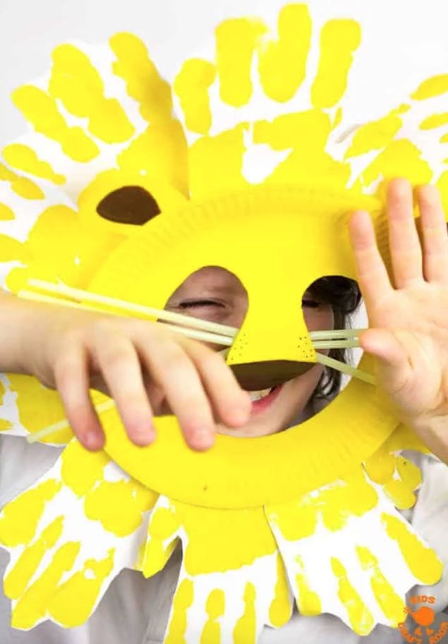 Lion mask made out of a paper plate and handprints