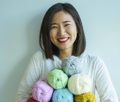 arms full of multicoloured yarn