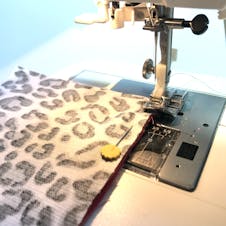 sewing machine with zipper foot sewing zip into place
