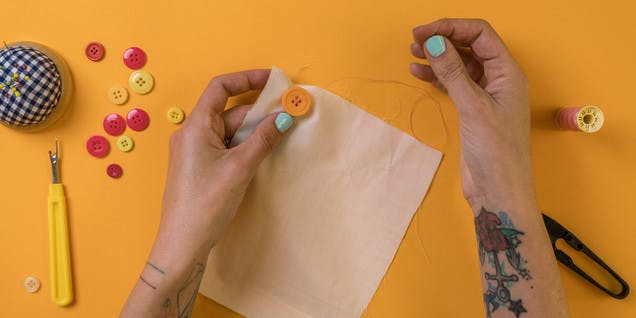 thread needle through button holes