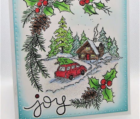 Christmas card with stamped winter cabin and car driving up to the house