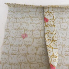 Sewing your bag straps to the body of your tote.