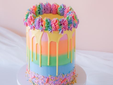 Learn how to decorate a rainbow layer cake with bold and bright icing