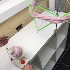 Turn yarn winder to create yarn ball