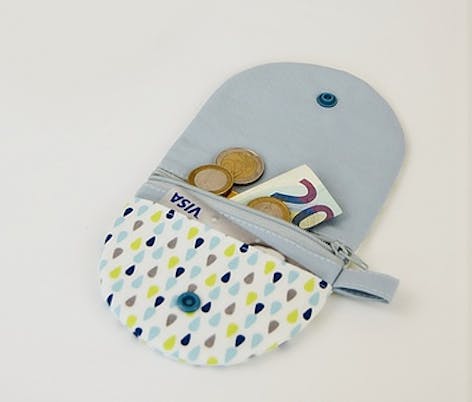 sewn coin purse with zip compartment, lined with plastic popper close