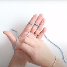 Loop the yarn around two fingers to start finger knitting