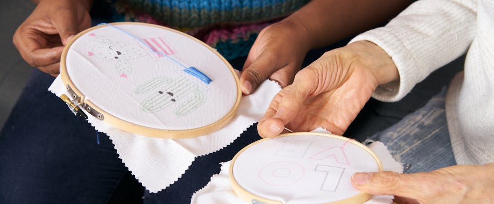 two people doing embroidery together 