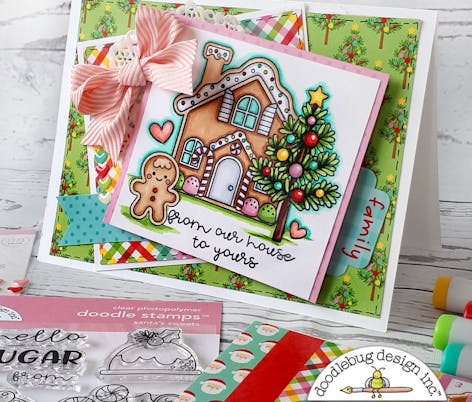 stamped ginger bread house with a tree and gingerbread man. Writing that says "from our hour to yours"