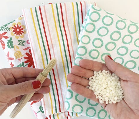what you need to make your own beeswax food wraps - fabric, paintbrush and beeswax pellets