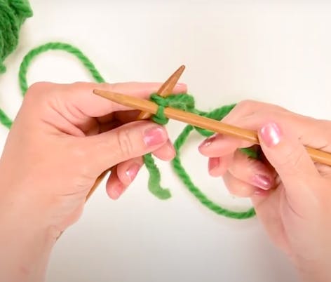 Bring your right hand needle, in front of the left.