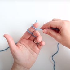 wrapping the yarn around your yarn to finger knit