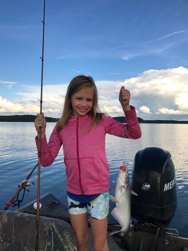 Little girl poses with catfish caught on Kentucky lake with Loveless Outdoor Adventures