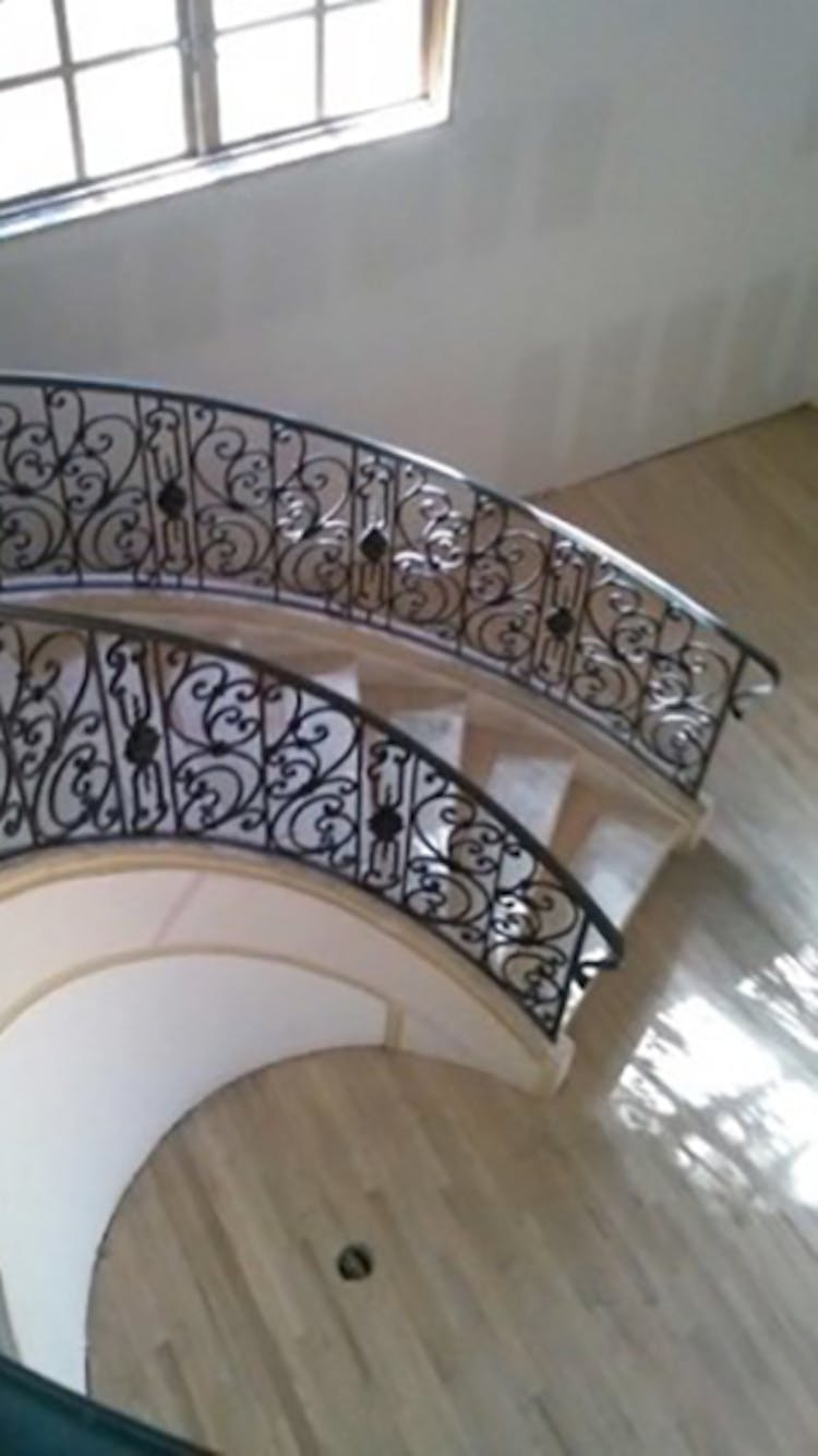 Functional iron railing, providing stability and security for staircases or balconies.