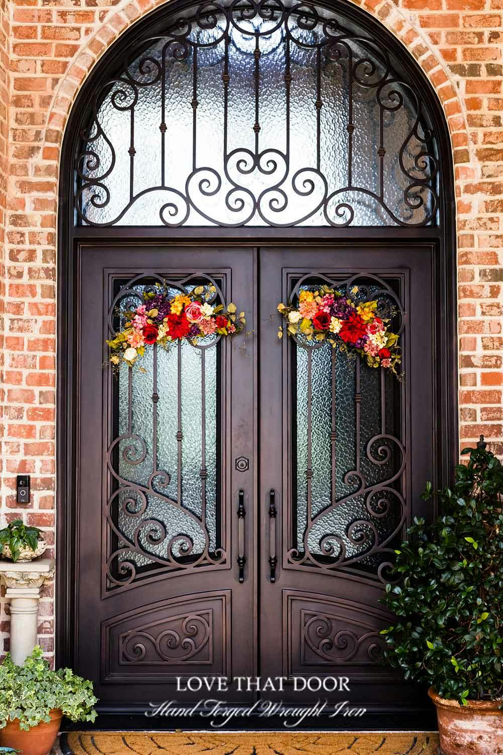 Awe-inspiring iron entryway with transom, creating a grand and welcoming statement.