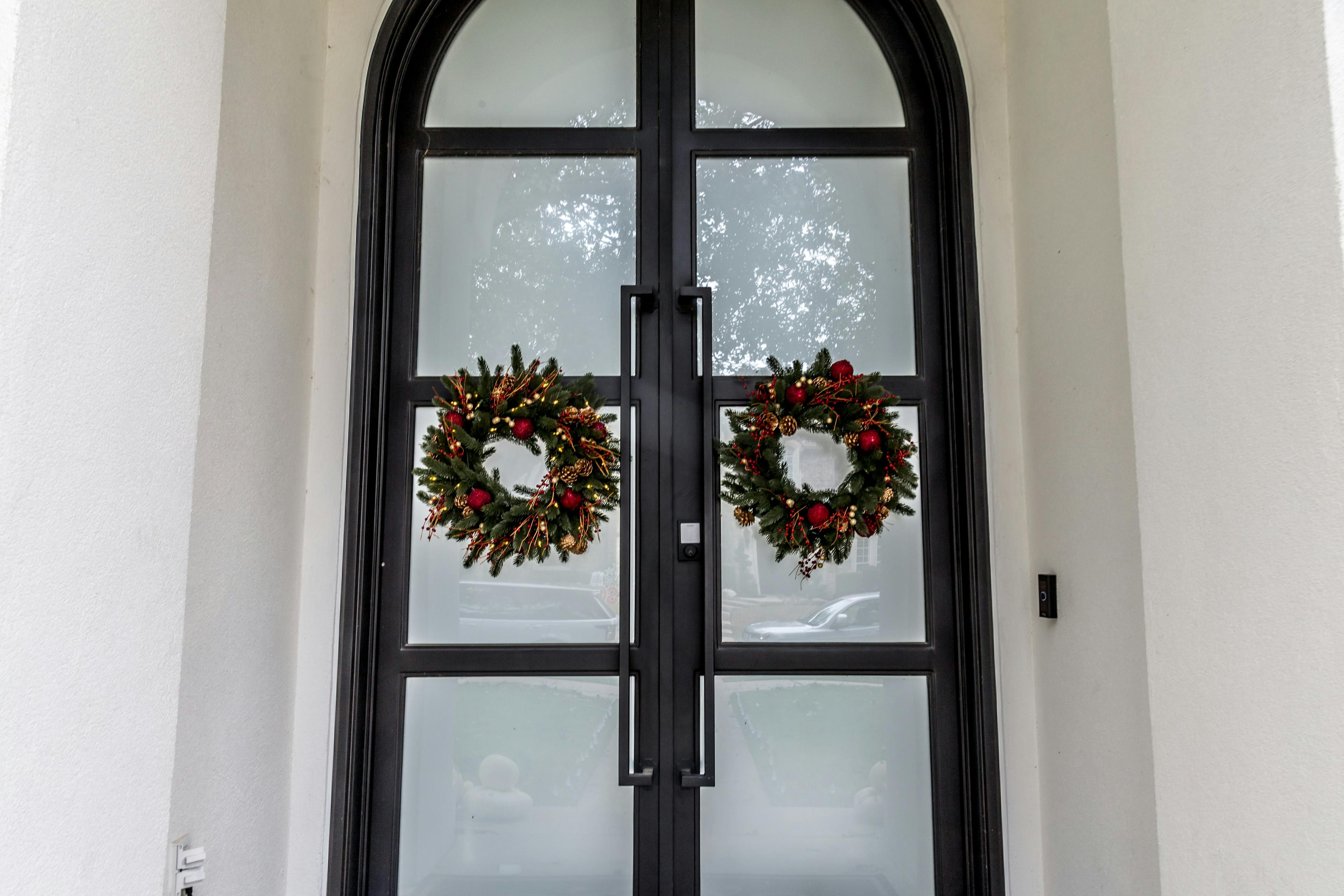 Iron door with arched glass panel and timeless design