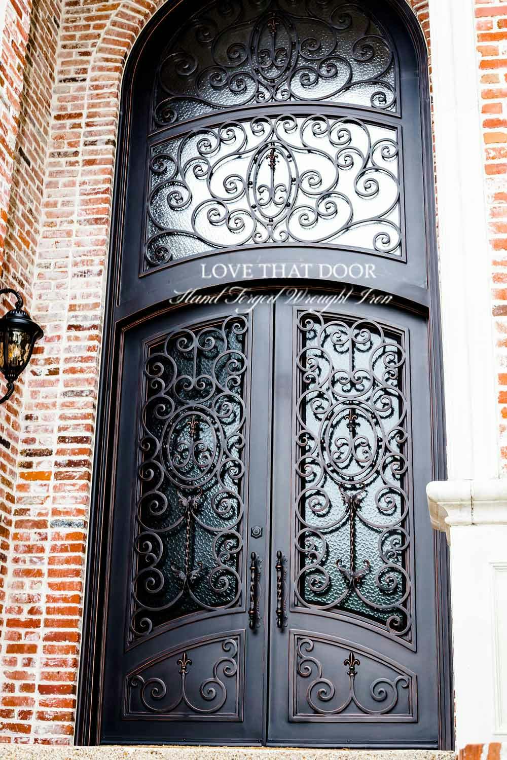 Elegant iron door and transom ensemble, exuding a perfect balance of strength and beauty.