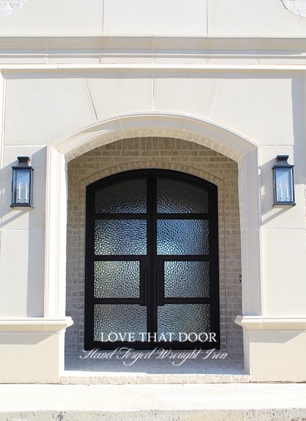 Elegant iron double doors with arched glass panels and timeless appeal