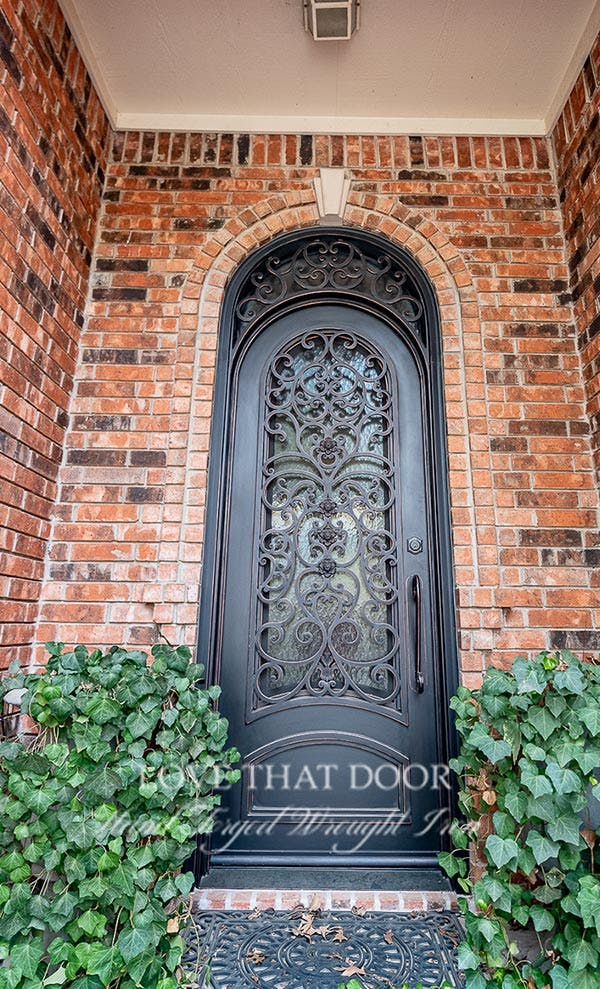 Single iron front door with beautiful scrollwork and accents