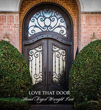 Custom wrought iron double door with grand entrance and transom